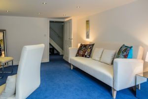 Basement Conversion into an office with living area and white sofa. Moorland Road, Didsbury, Greater Manchester